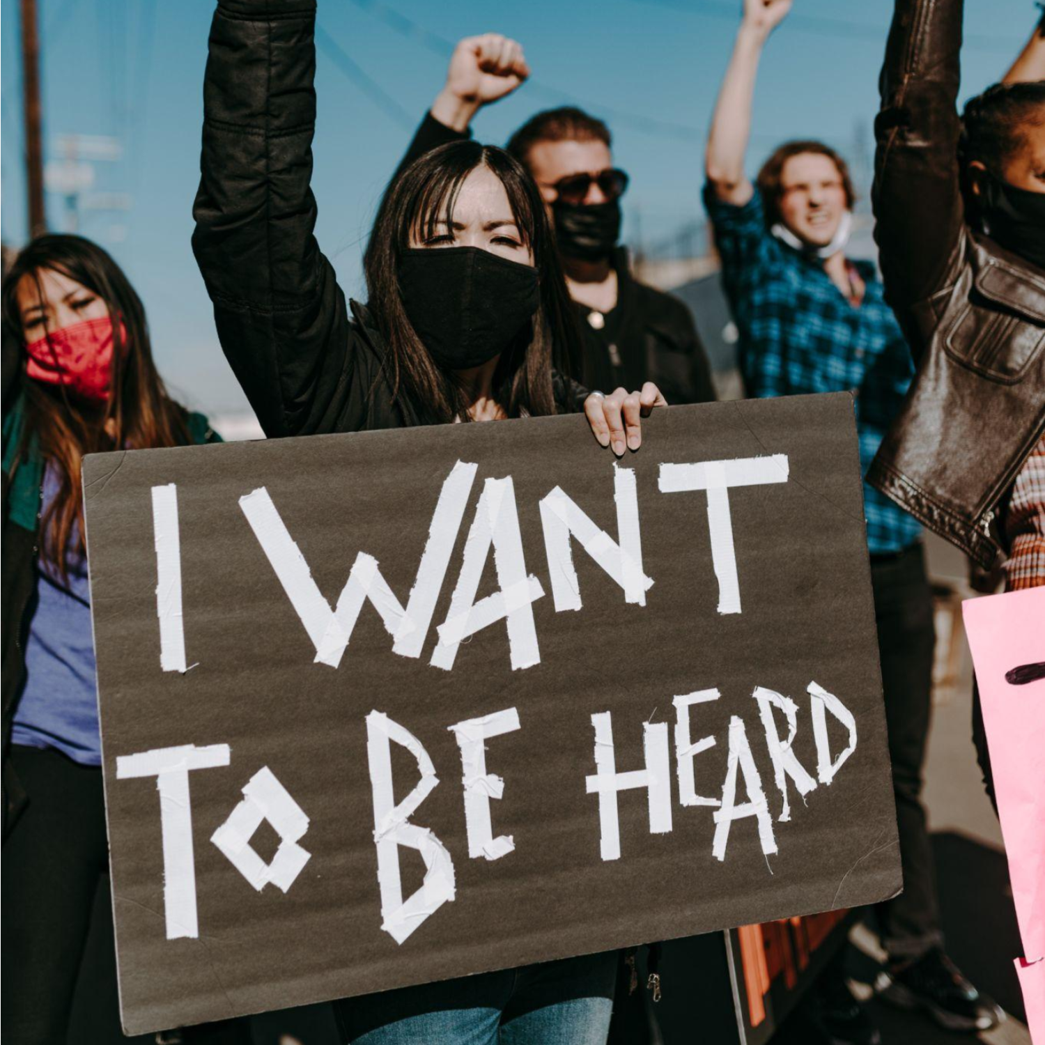 Gender equality protest featuring "I want to be heard" sign